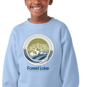 Smiling child wearing a light blue sweatshirt with a circular Forest Lake Education Center logo featuring a tree by a lake.